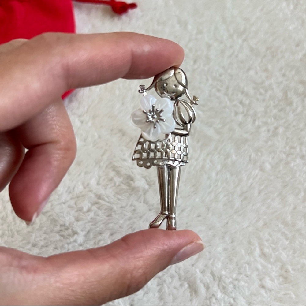Silver brooch girl with a flower